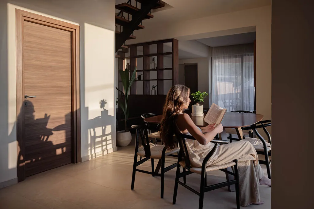 Open-plan living and dining area with walnut shelving