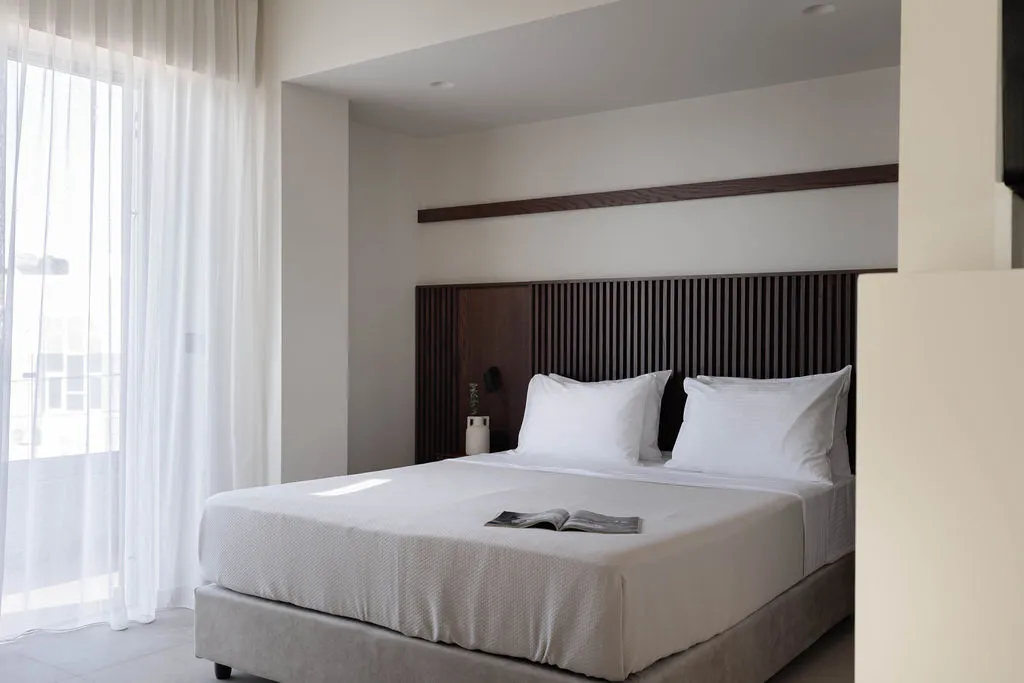 Bedroom with king-size bed and timber headboard