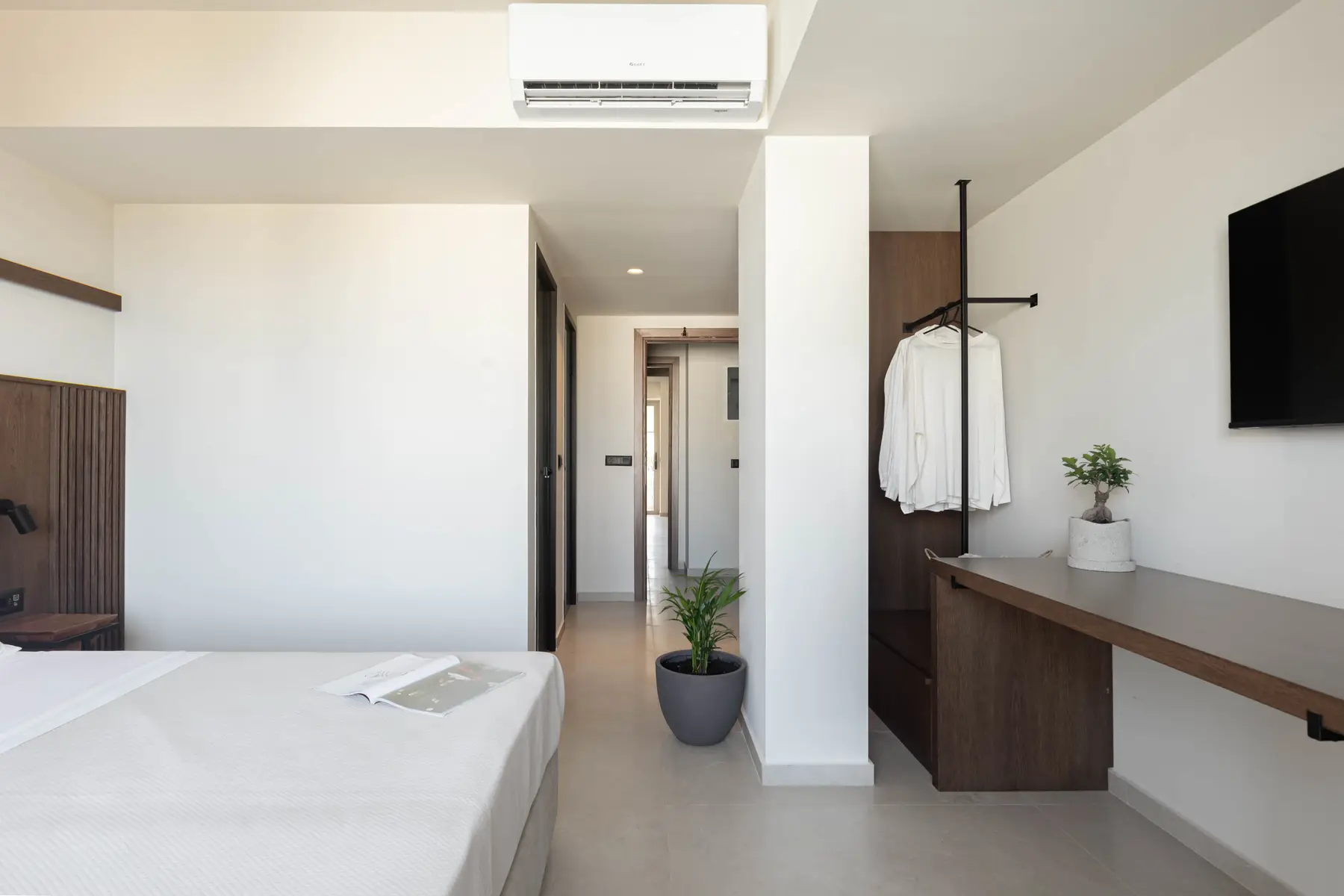 Bedroom with hanging rail and desk along the corridor