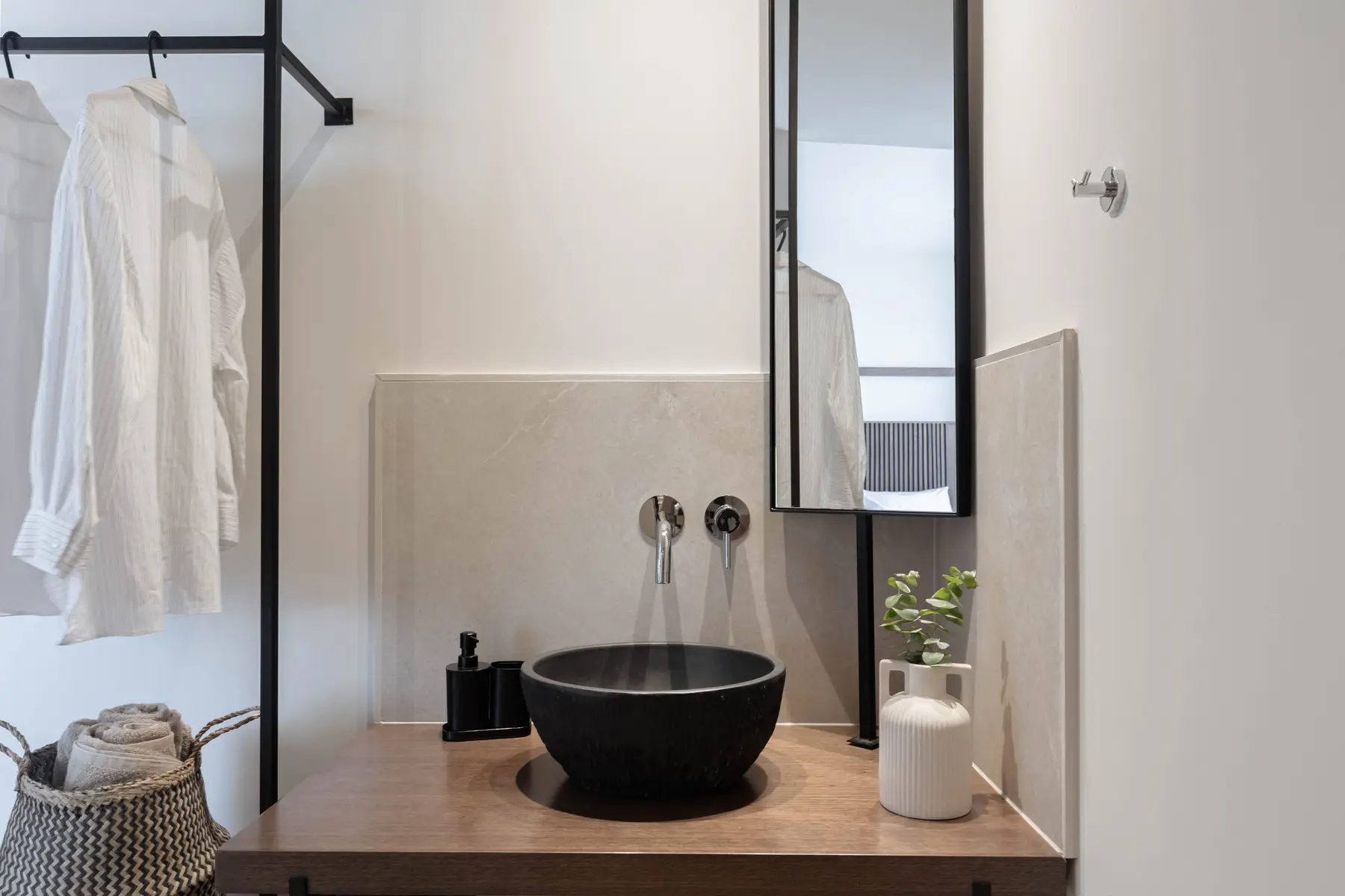 Black stone basin on the walnut vanity