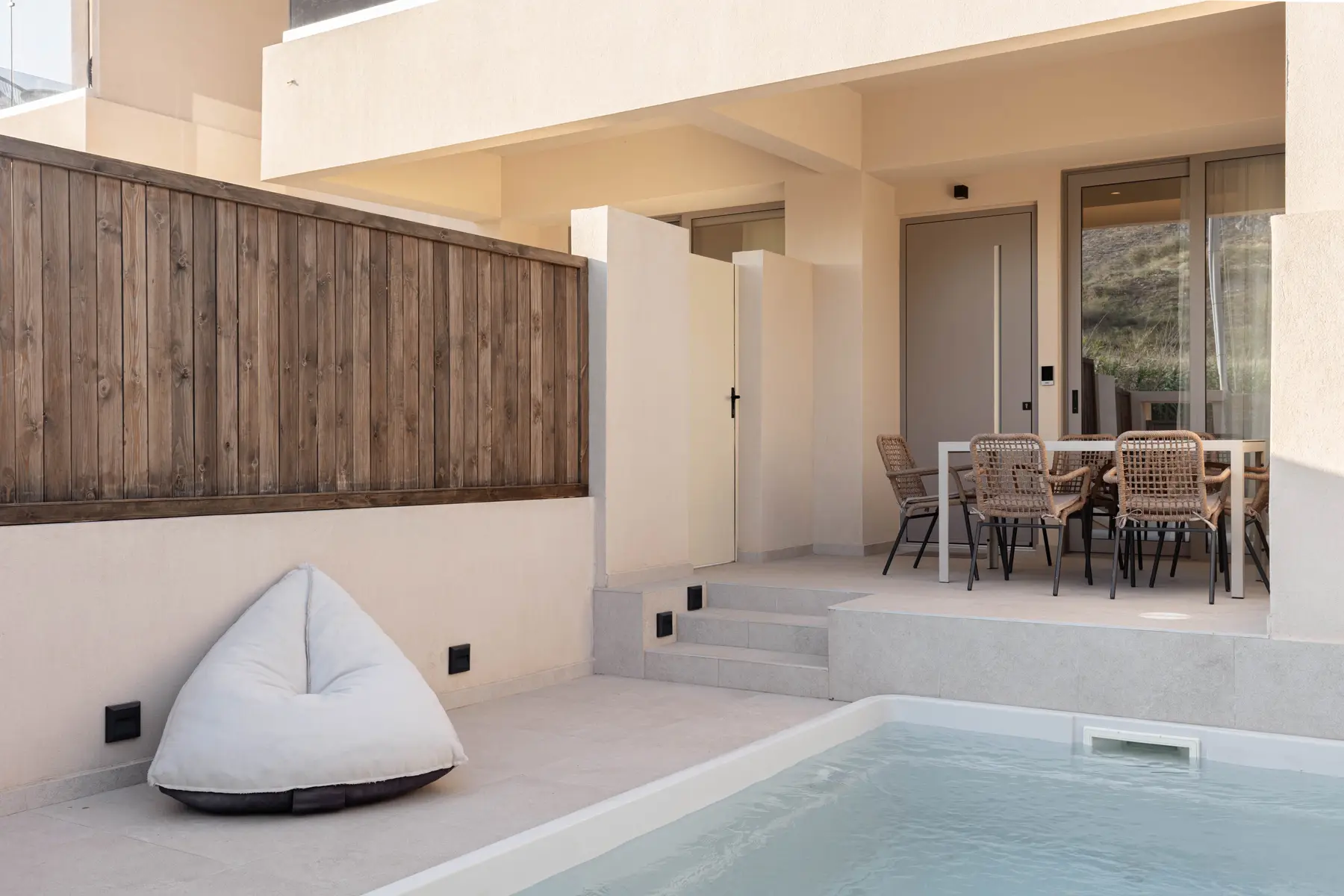 Steps from the covered terrace down to the pool