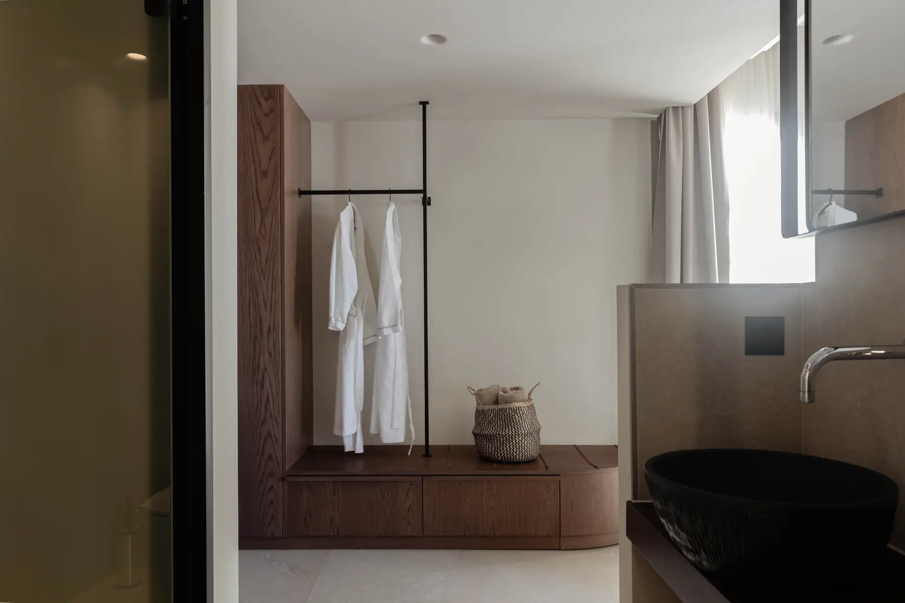 Bathrobes and towel basket on the oak dressing bench