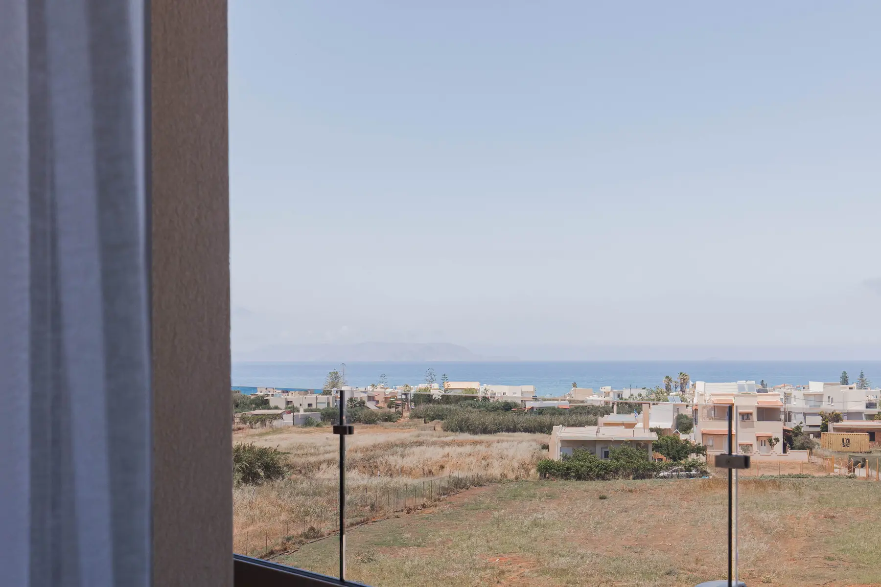 View over the rooftops to the sea from the upper floor