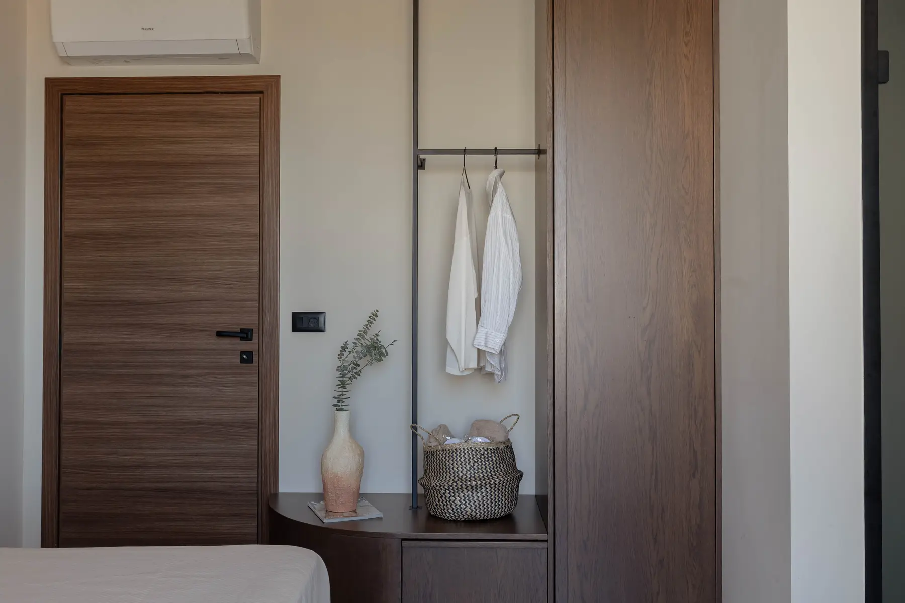 Oak wardrobe and hanging rail beside the bedroom door